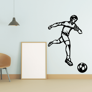 Soccer wall decal of black soccer player kicking ball with soccer ball outline