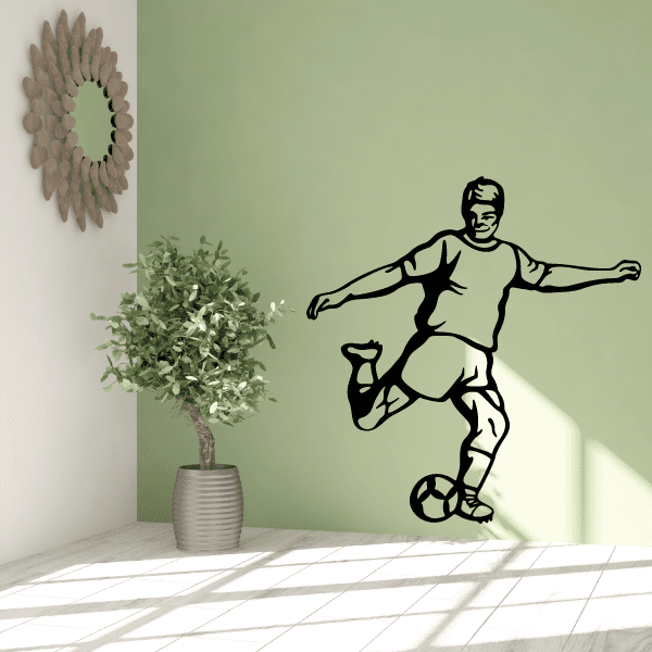 Soccer player wall decal, black vinyl silhouette with soccer ball and boots.