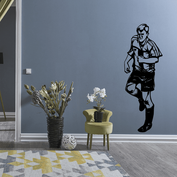 Black soccer player wall vinyl decal, running pose with ball under arm