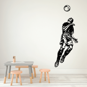 Soccer player vinyl wall decal with a ball, black outline on light background