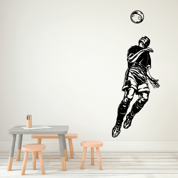 Soccer player vinyl wall decal with a ball, black outline on light background