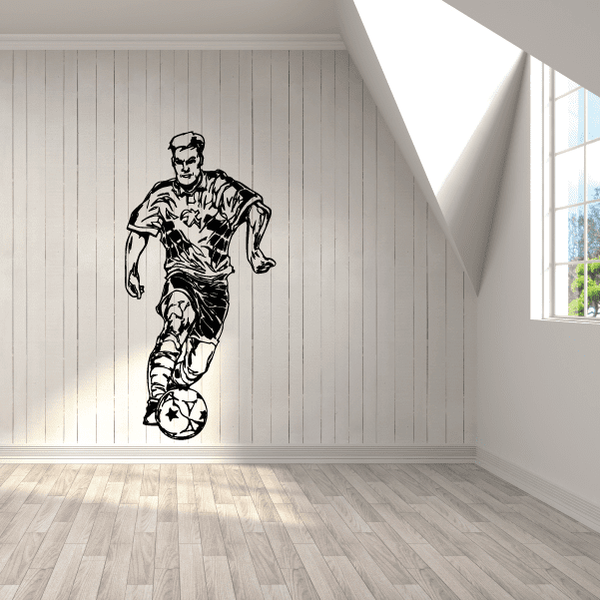 Soccer wall decal of a black-and-white soccer player with ball on striped wall