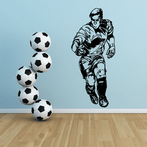 Soccer wall decal of a running player with black-and-white soccer balls