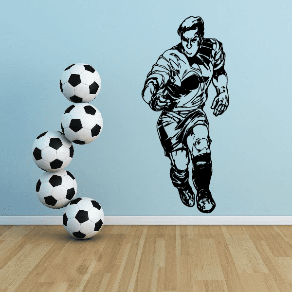 Soccer wall decal of a running player with black-and-white soccer balls