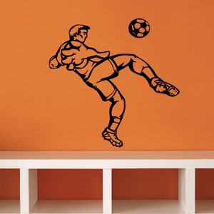 Black vinyl soccer wall decal of a player kicking a soccer ball