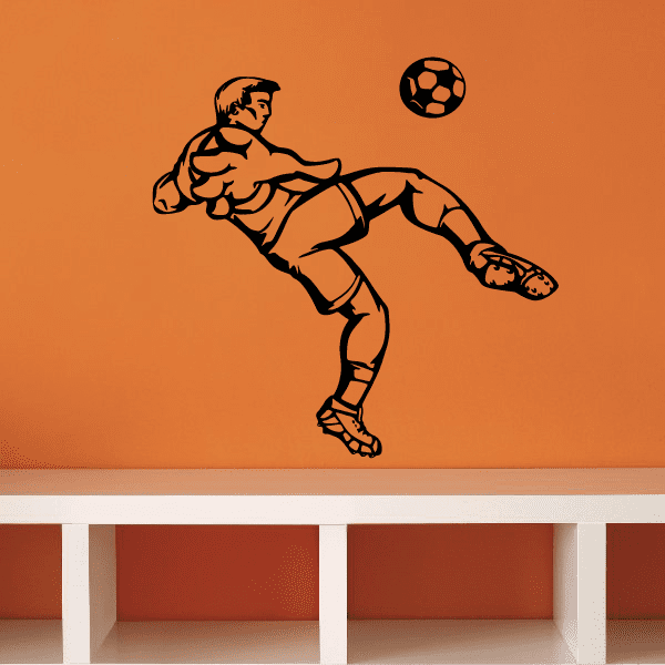 Black vinyl soccer wall decal of a player kicking a soccer ball