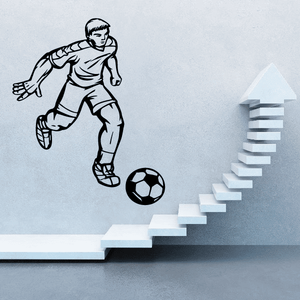 Soccer wall decal of player kicking ball with upward arrow