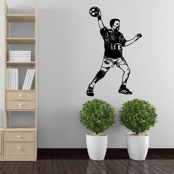 Black soccer player wall vinyl decal with ball above head, full-body silhouette.