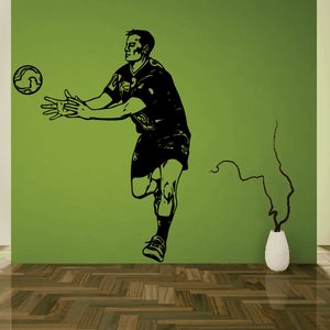 Soccer wall decal featuring black vinyl football player silhouette with ball