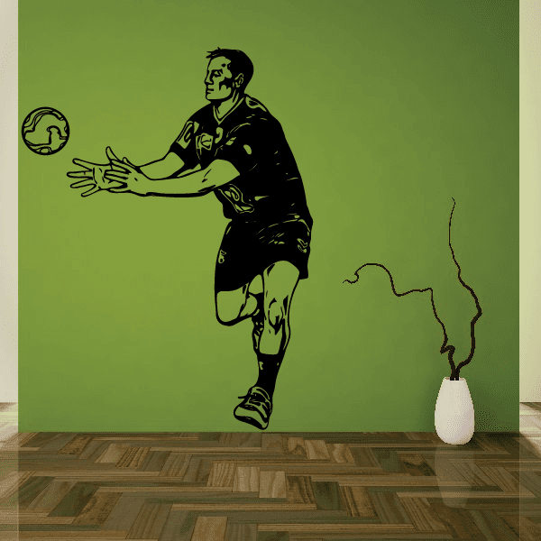 Soccer wall decal featuring black vinyl football player silhouette with ball