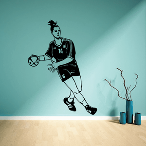 Soccer player wall decal, black vinyl figure holding soccer ball with jersey number 14.