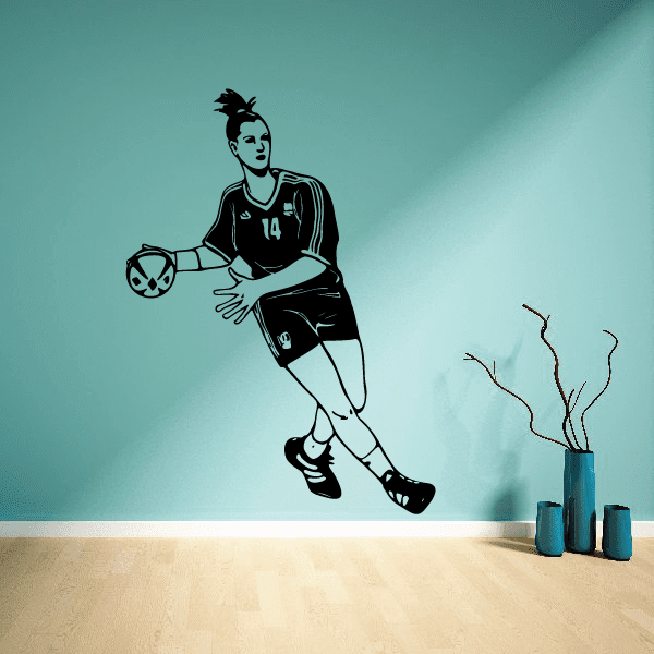 Soccer player wall decal, black vinyl figure holding soccer ball with jersey number 14.