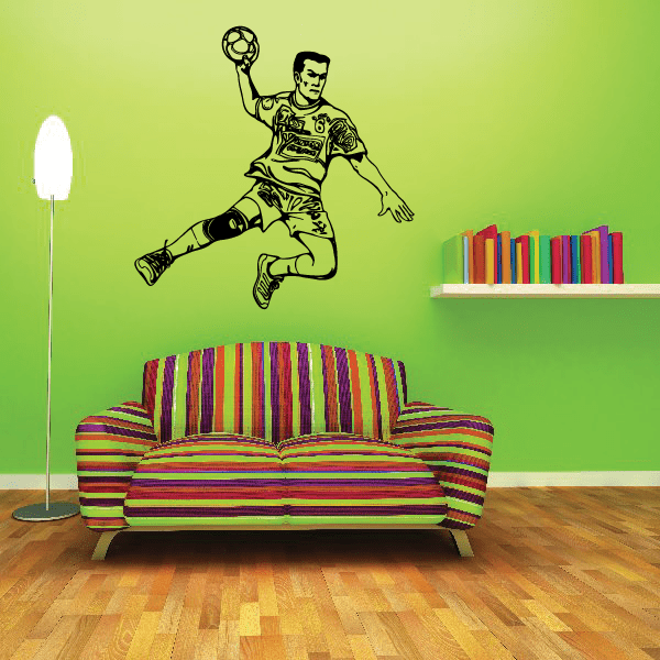 Vinyl soccer wall decal of a kneeling soccer player holding a ball
