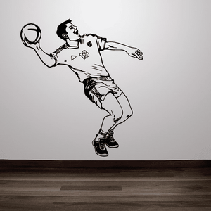 Soccer player wall decal, black vinyl style figure holding ball in shooting pose.