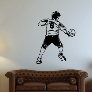 Black soccer player wall vinyl decal in ball-kick pose