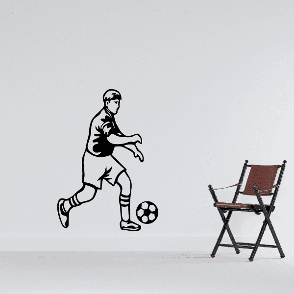 Soccer player vinyl wall decal in black, kicking a soccer ball