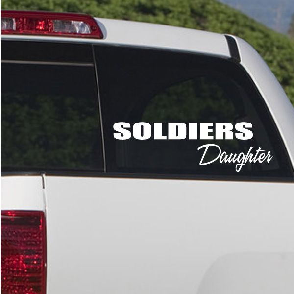 Car window decal reading Soldiers Daughter in white script on dark glass