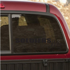 Decorative window decal with dark lettering on a car side window
