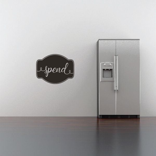 Black speech-bubble wall decal with cursive 'spend' lettering