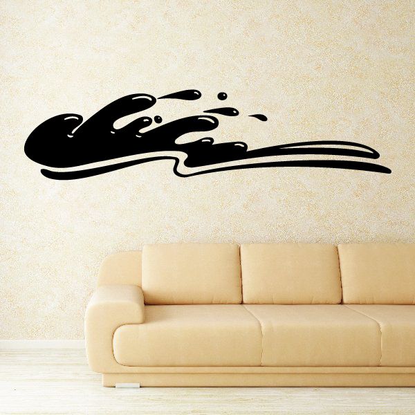 Black splash-shaped wall vinyl decal above a sofa
