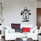 Black scarecrow wall decal with hat, dangling arms, and stitched smile