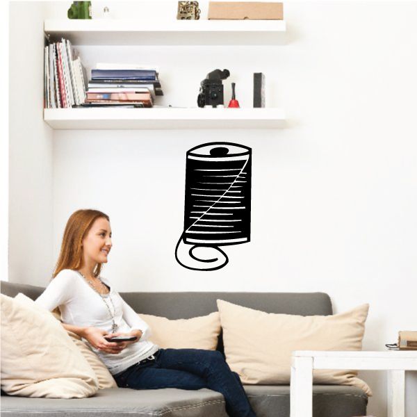 Thread spool decal, black outline with curved base and winding lines