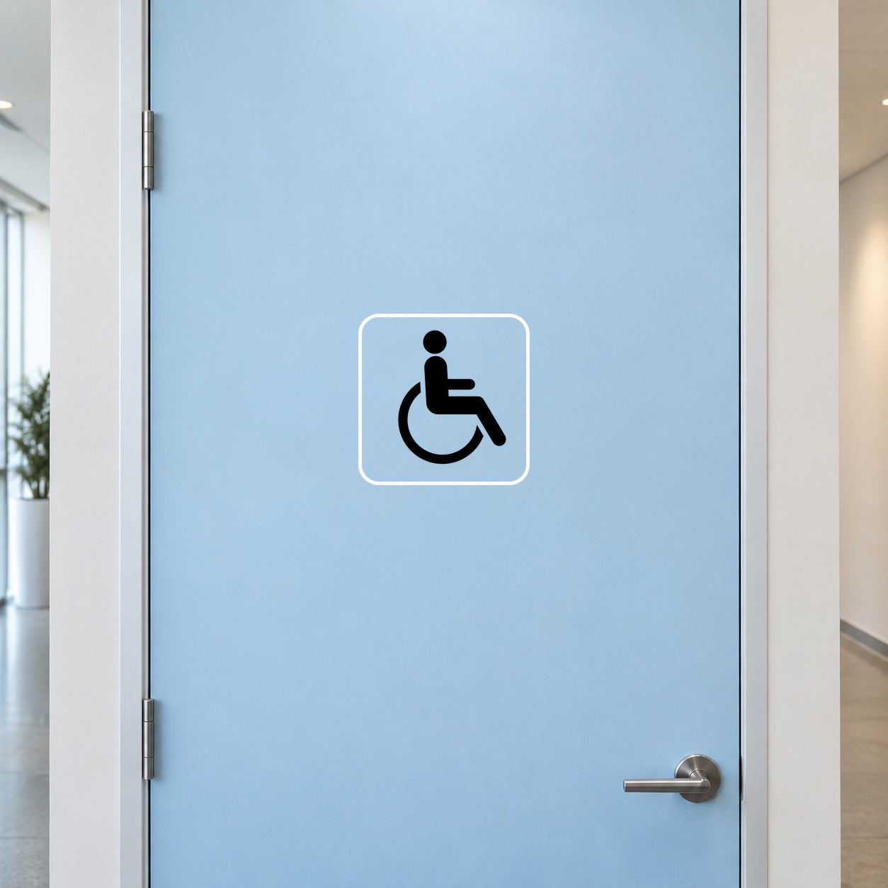 Wheelchair sign decal with wheelchair icon, white border on light blue door