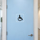 Wheelchair sign decal with wheelchair icon, white border on light blue door