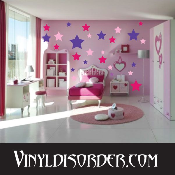 Star wall decal kit with colorful star stickers on a bedroom wall