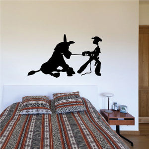 Black vinyl wall decal of a donkey and rider holding a tool