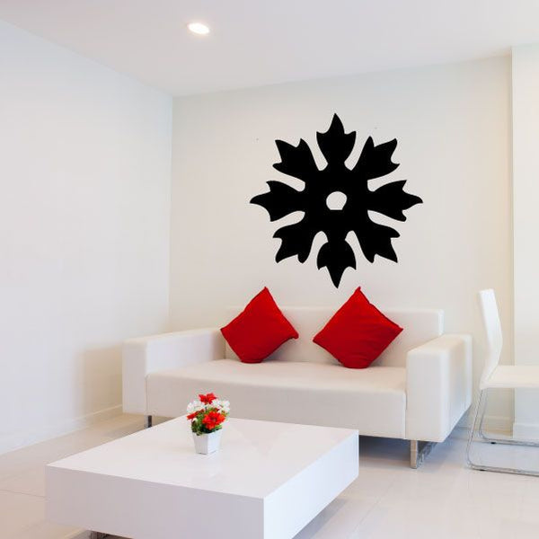 Black sunburst ninja star wall decal with spiky circular center