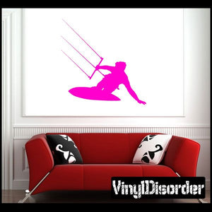 Pink surfing vinyl wall decal of a surfer on a board, bold silhouette