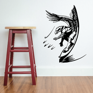 Surfing wall decal of a surfer riding a wave, black vinyl graphic