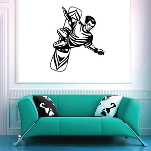 Surfing wall decal of black surfer silhouette on a white surface