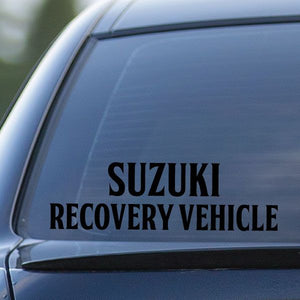 Vehicle decal text 'SUZUKI RECOVERY VEHICLE' on car window