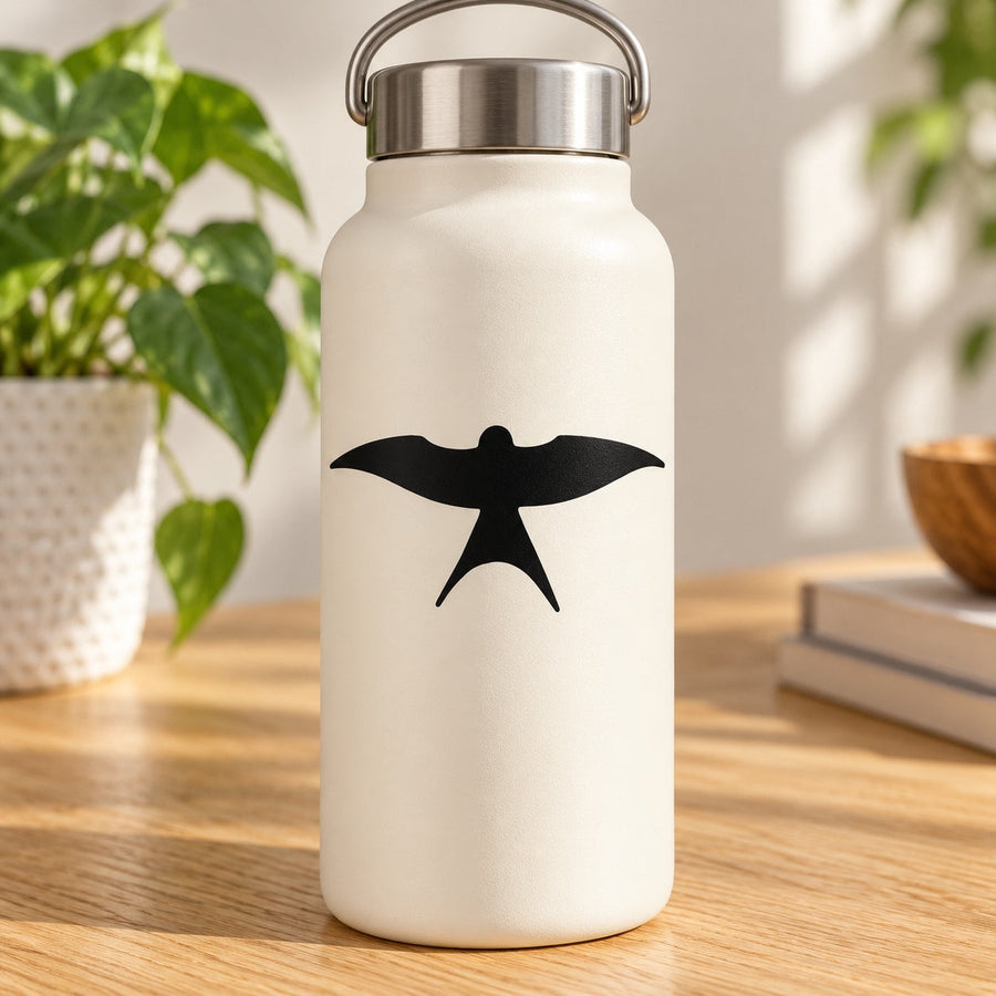 Black swallow wings decal on a light-colored water bottle