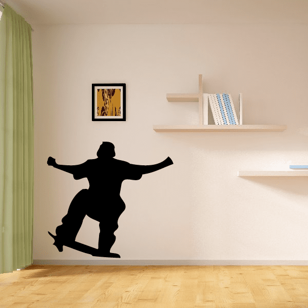 Skateboarding decal featuring black tail-grind skateboarder silhouette on wall