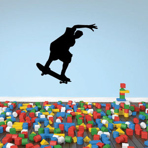 Black skateboarder silhouette vinyl wall decal, mid-trick pose