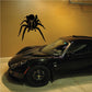 Black tarantula spider decal with front legs raised, approaching design