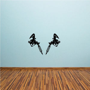 Tattoo gun vinyl decal showing two black tattoo guns with stylized text