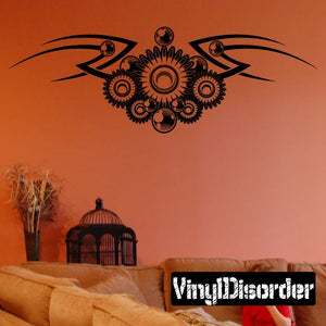 Vinyl wall decal with black tribal wing and orange floral sunburst design