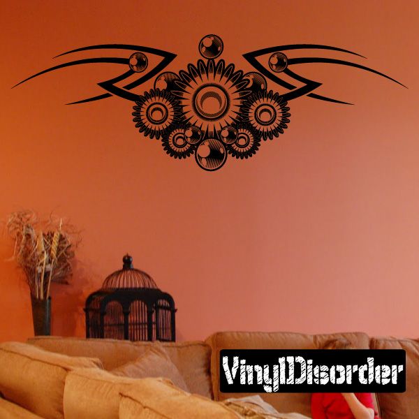 Vinyl wall decal with black tribal wing and orange floral sunburst design