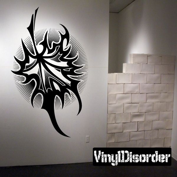 Black tribal tattoo wall decal with bold swirls and face-like design