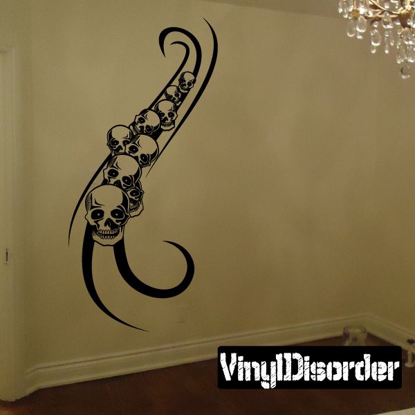 Skull tattoo wall decal in black vinyl, with five skulls and curling flame-style hook
