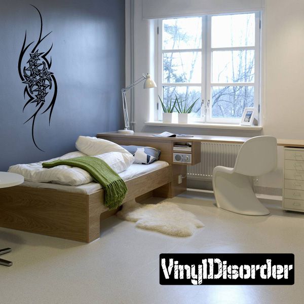 Black vinyl tattoo wall decal with starburst and swirling tribal pattern