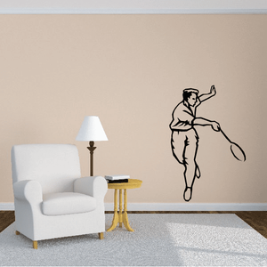 Tennis wall decal of a black tennis player silhouette mid-swing on a wall