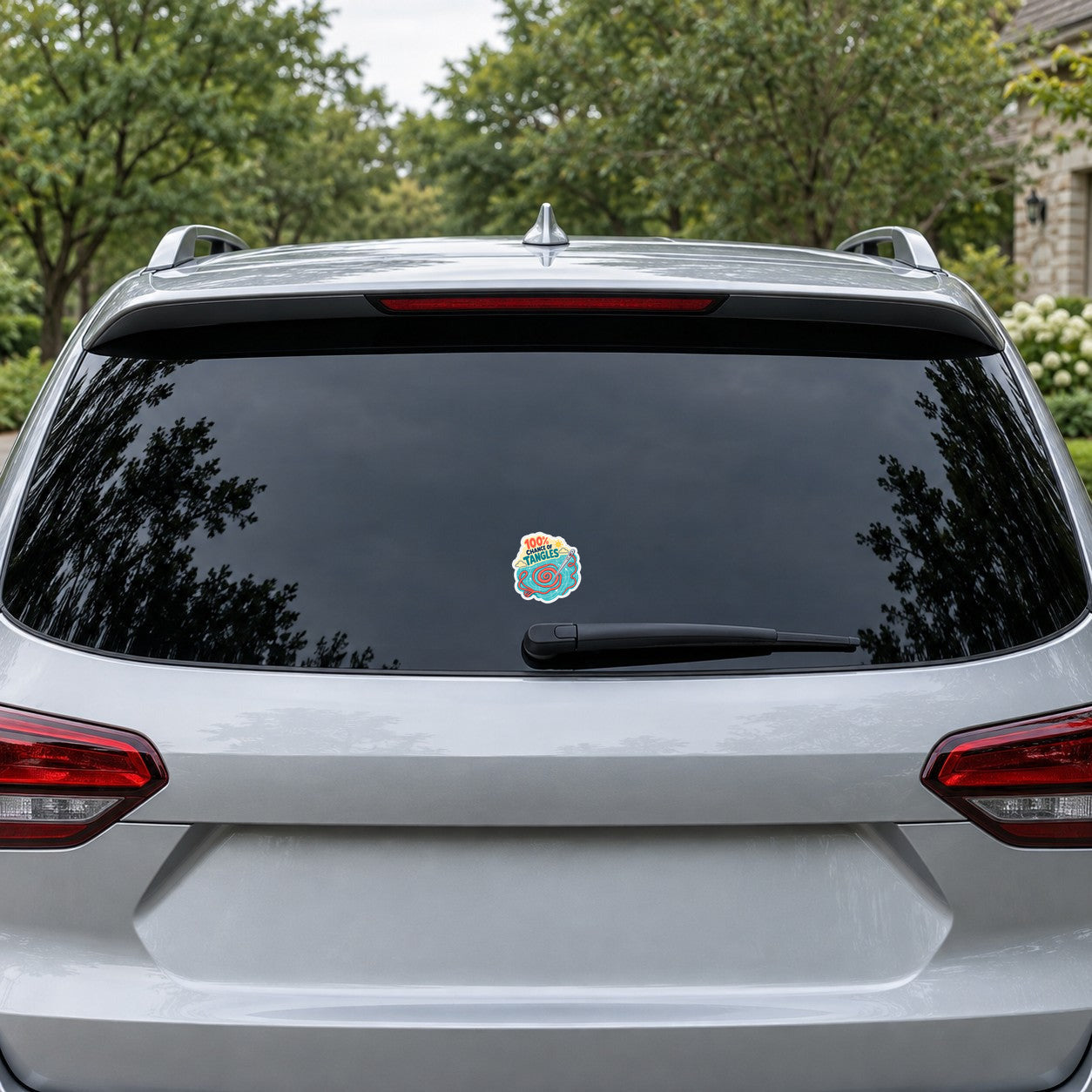 Vinyl sticker on car rear window: spiral yarn graphic with “100% chance of tangles”.