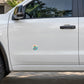 Vinyl sticker on car door: colorful spiral yarn and “100% chance of tangles” text.