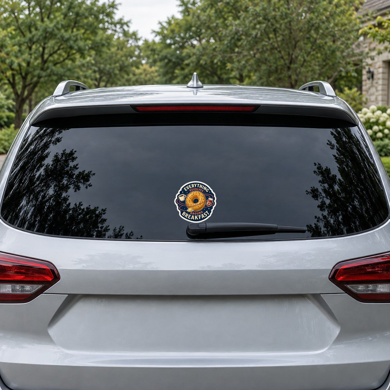 Bagel Orbit Club sticker on car rear window, circular bagel logo with breakfast text
