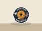 Round sticker with donut, coffee cup, and jam jars; reads “EVERYTHING REVOLVES” “AROUND BREAKFAST”.